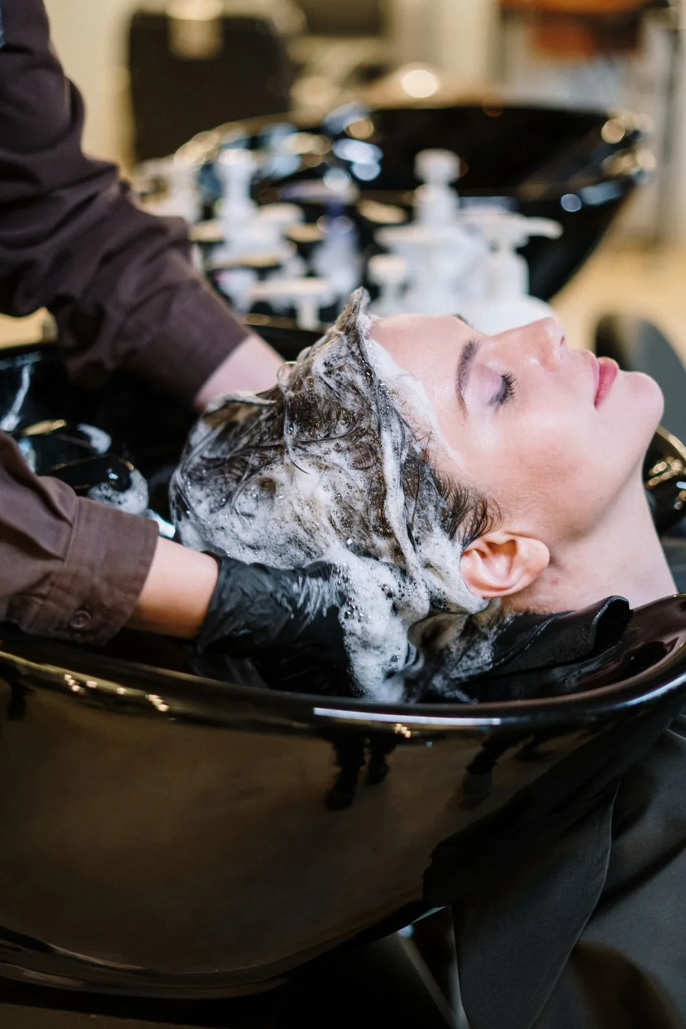 Hair-care professional treating a client's hair