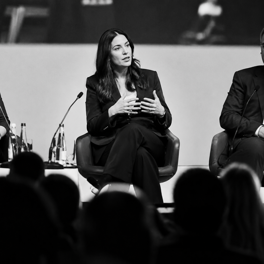 Expert speaking on a conference panel in front of an audience